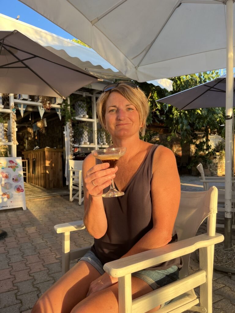 Jackie Hall smiling with an espresso martini in her hand.
